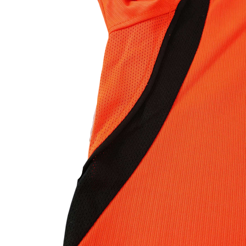 Close-up of an orange sports jersey with black and gray accents on a white background